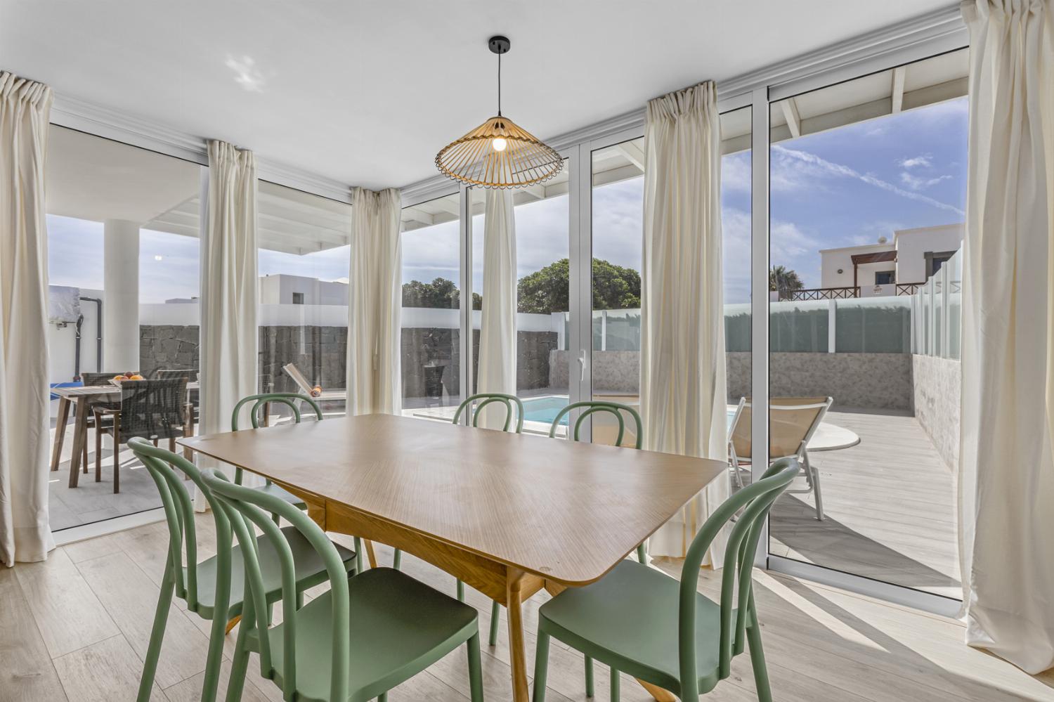 ,Open-plan living room with sofa, dining area, kitchen, WiFi internet, satellite TV, and sea views