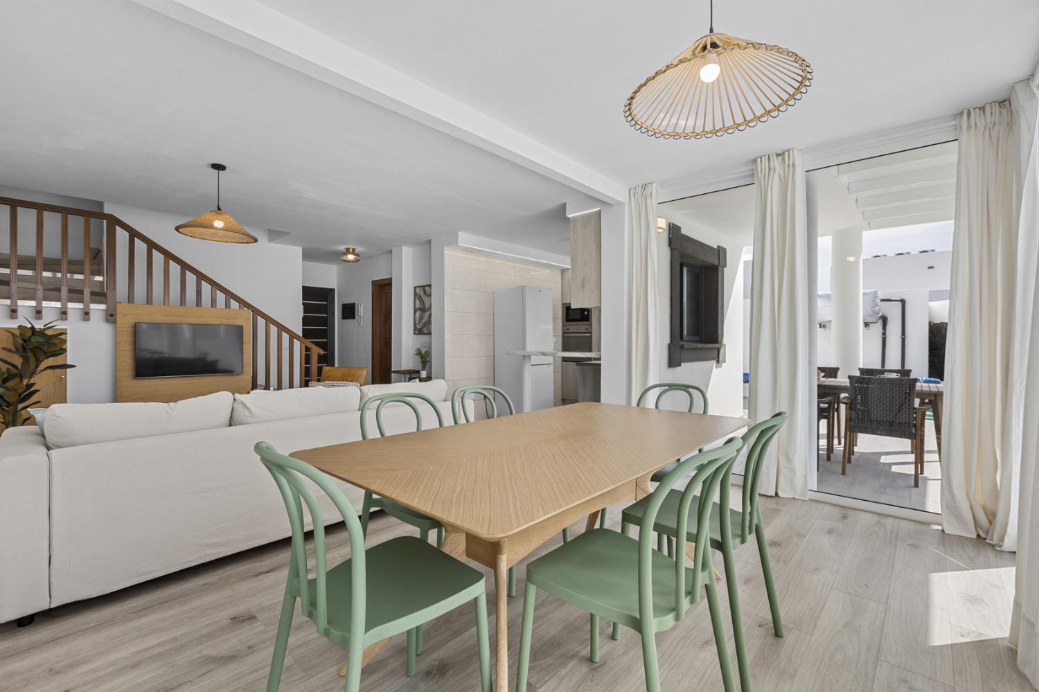Open-plan living room with sofa, dining area, kitchen, WiFi internet, satellite TV, and sea views