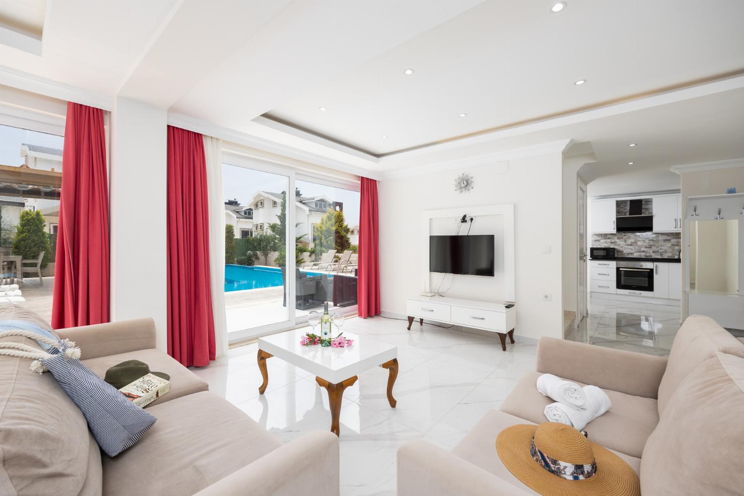 Living room with sofas, dining area, A/C, WiFi internet, and satellite TV