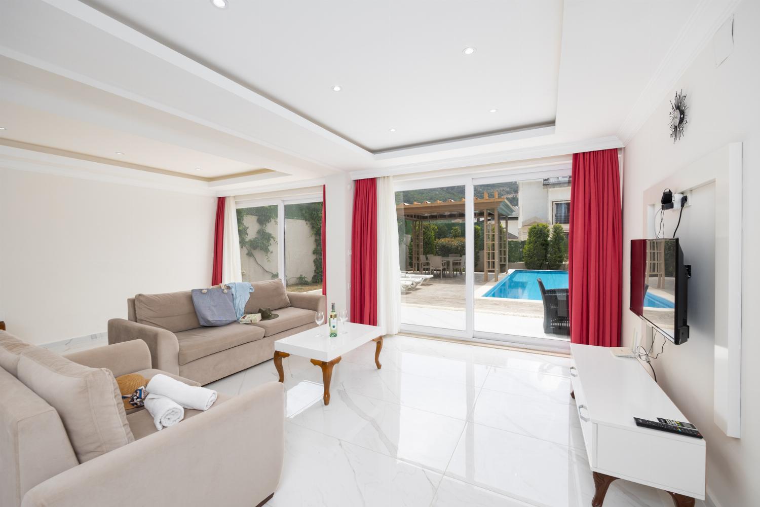 Living room with sofas, dining area, A/C, WiFi internet, and satellite TV