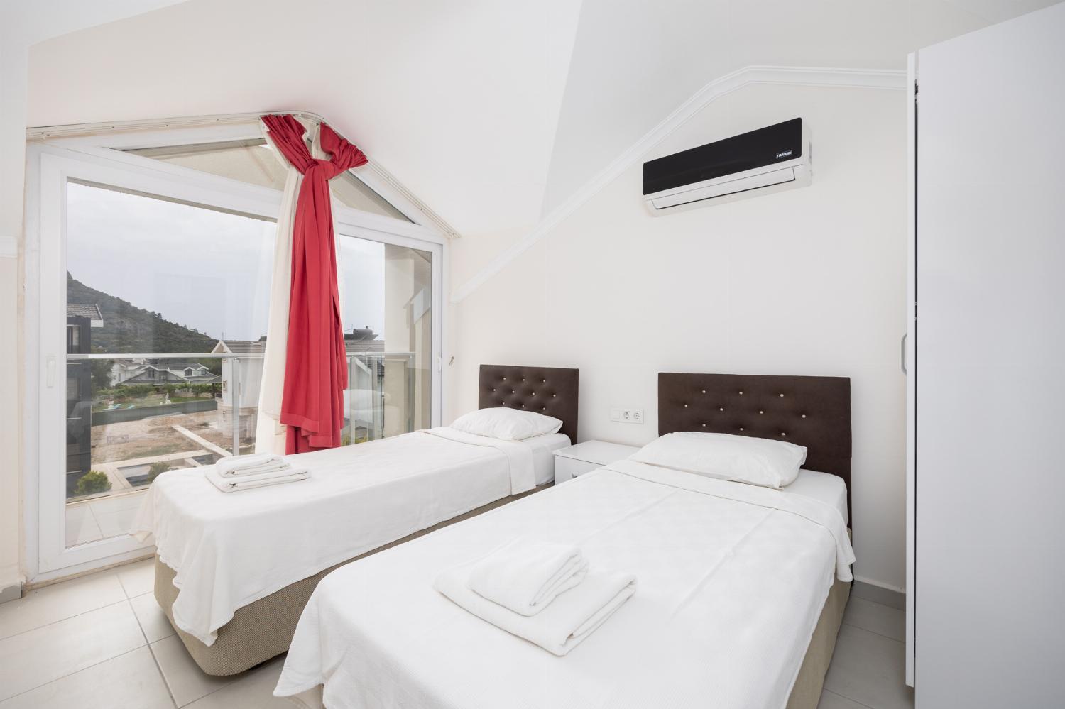 Twin bedroom with en suite bathroom and A/C