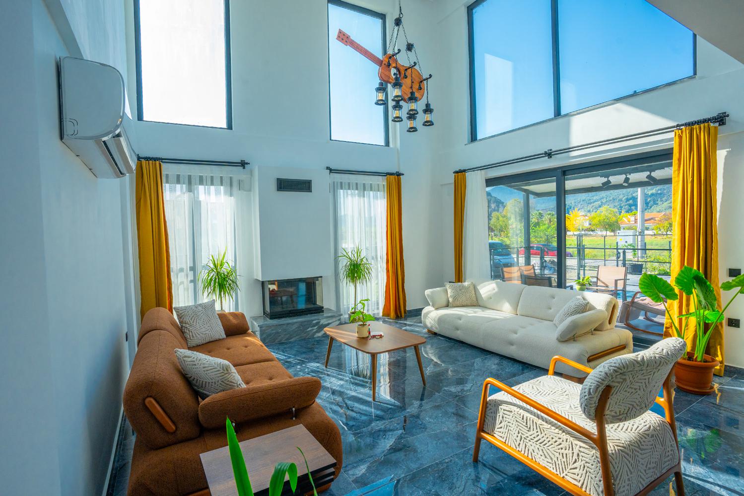Open-plan living room with sofas, dining areas and kitchen