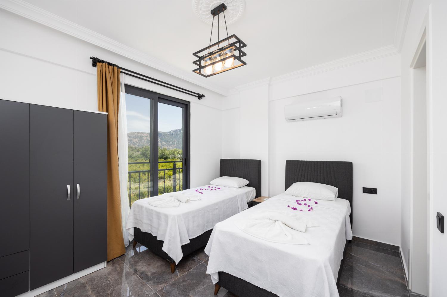 Twin bedroom with en suite bathroom and A/C