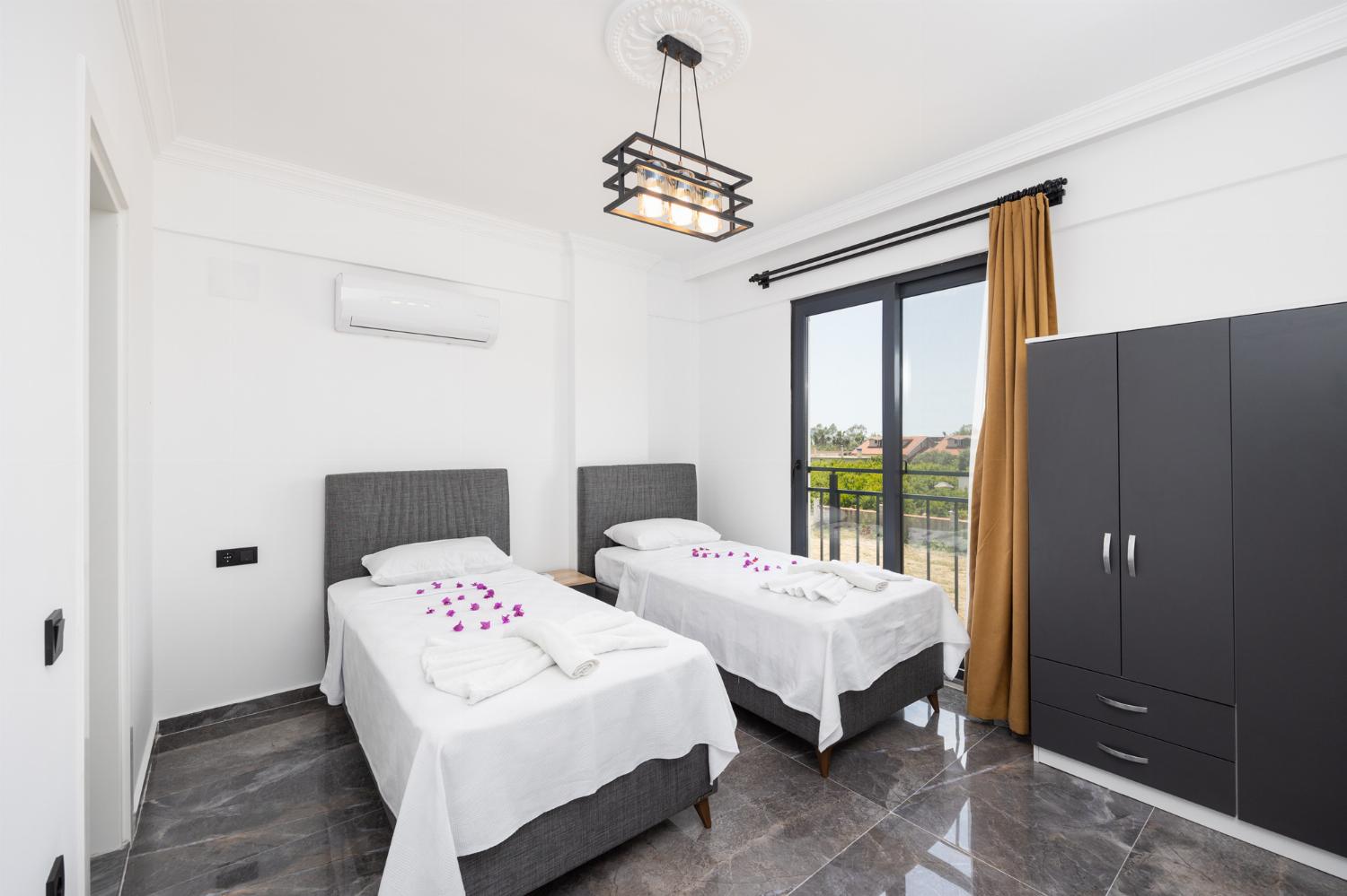 Twin bedroom with en suite bathroom and A/C