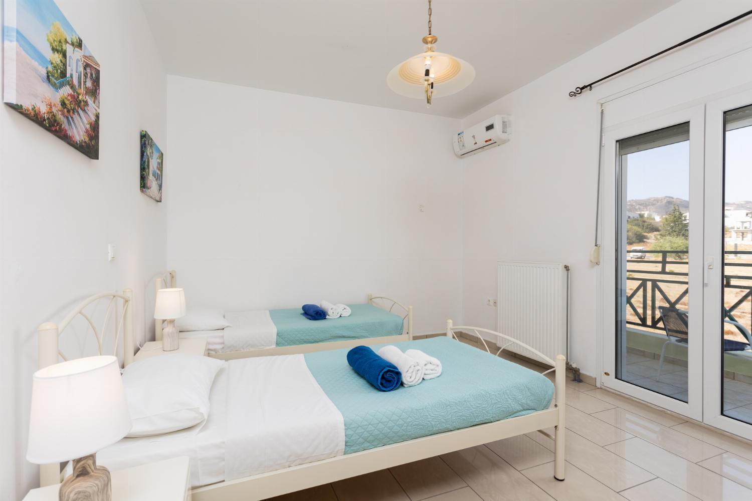 Twin bedroom with A/C and balcony access