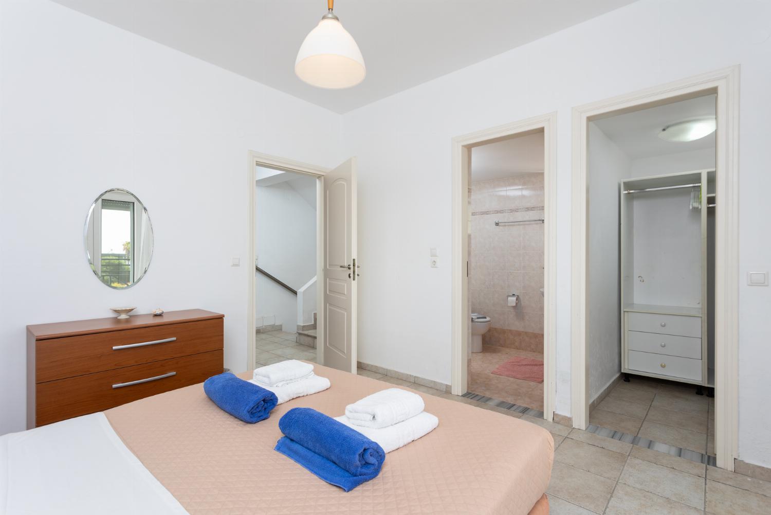 Double bedroom with en suite bathroom, A/C, and balcony access