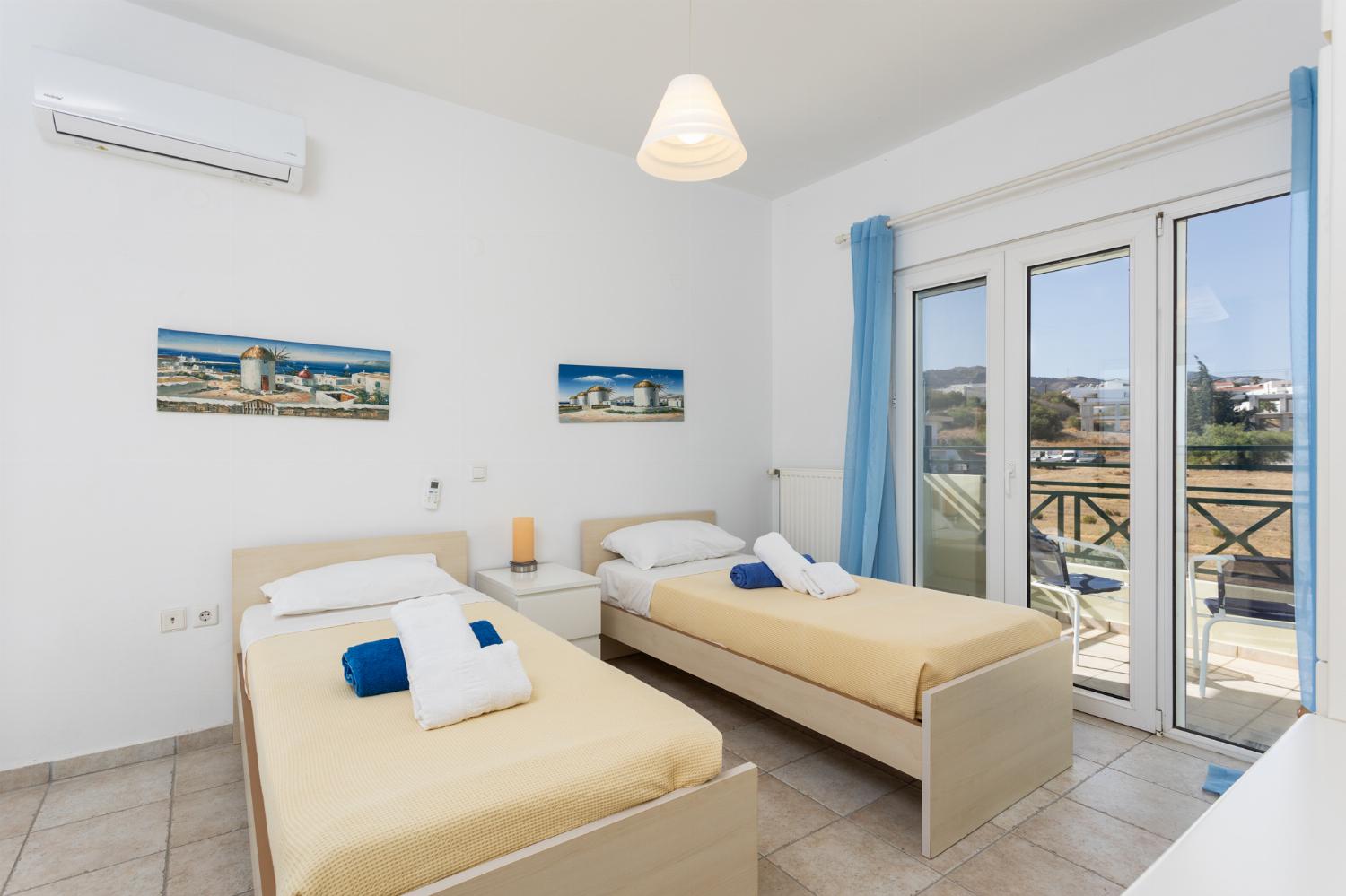 Twin bedroom with A/C and balcony access