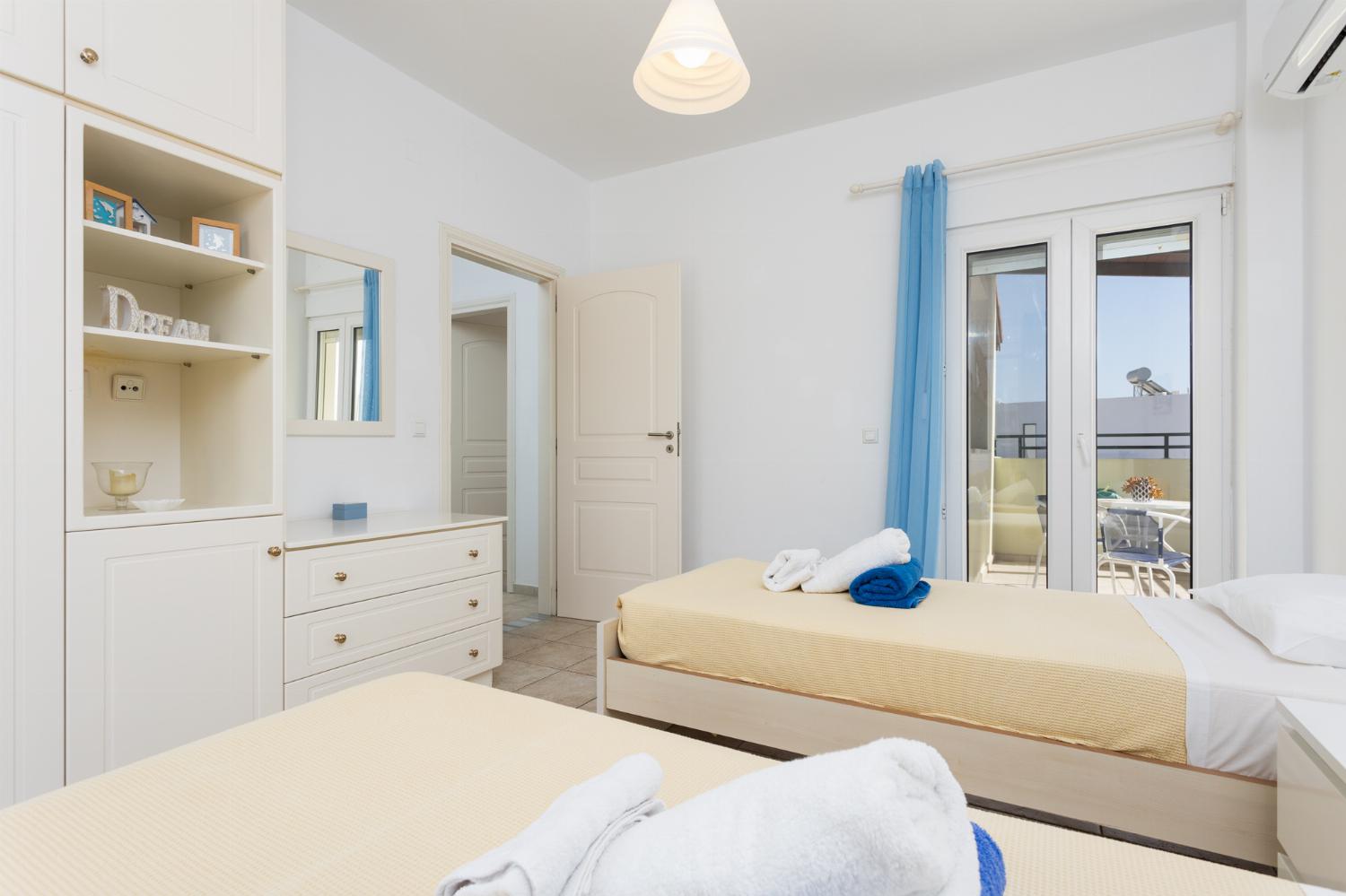 Twin bedroom with A/C and balcony access