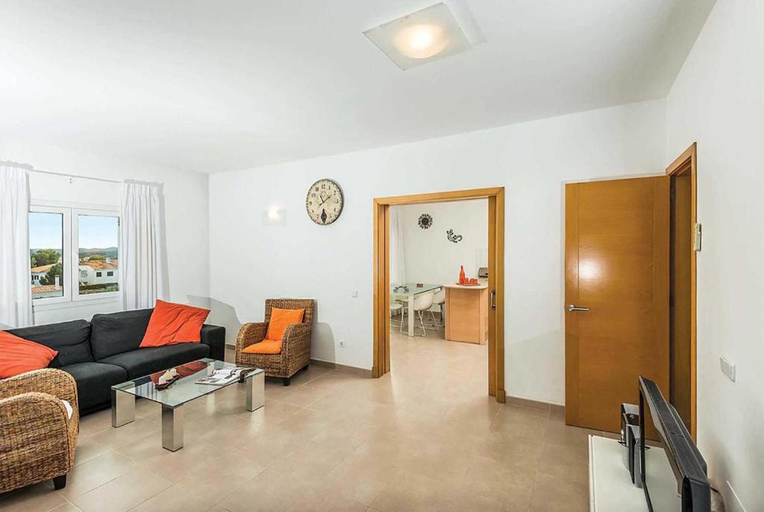 Open plan living room with A/C, TV, WiFi, comfortable sofas, patio doors