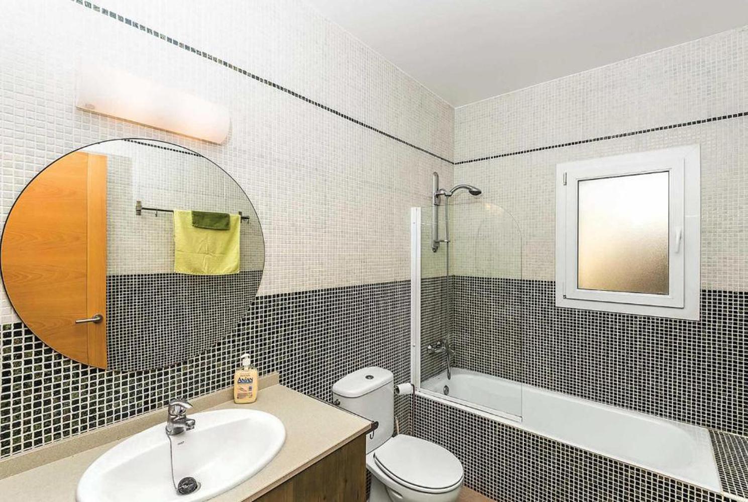 En suite bathroom with bath and WC