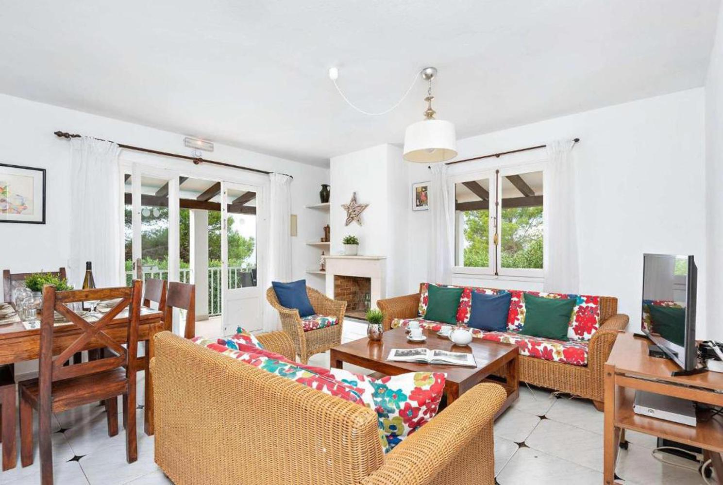 Open plan living room with A/C patio doors comfortable sofas, WiFi, TV dining area