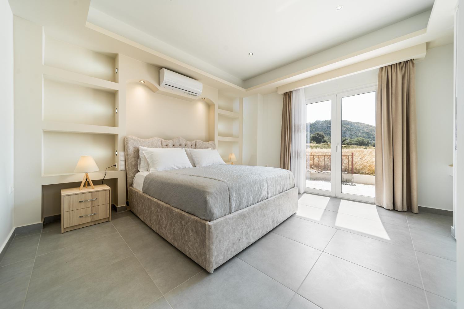 Double bedroom with A/C, en suite and upper terrace access with panoramic views