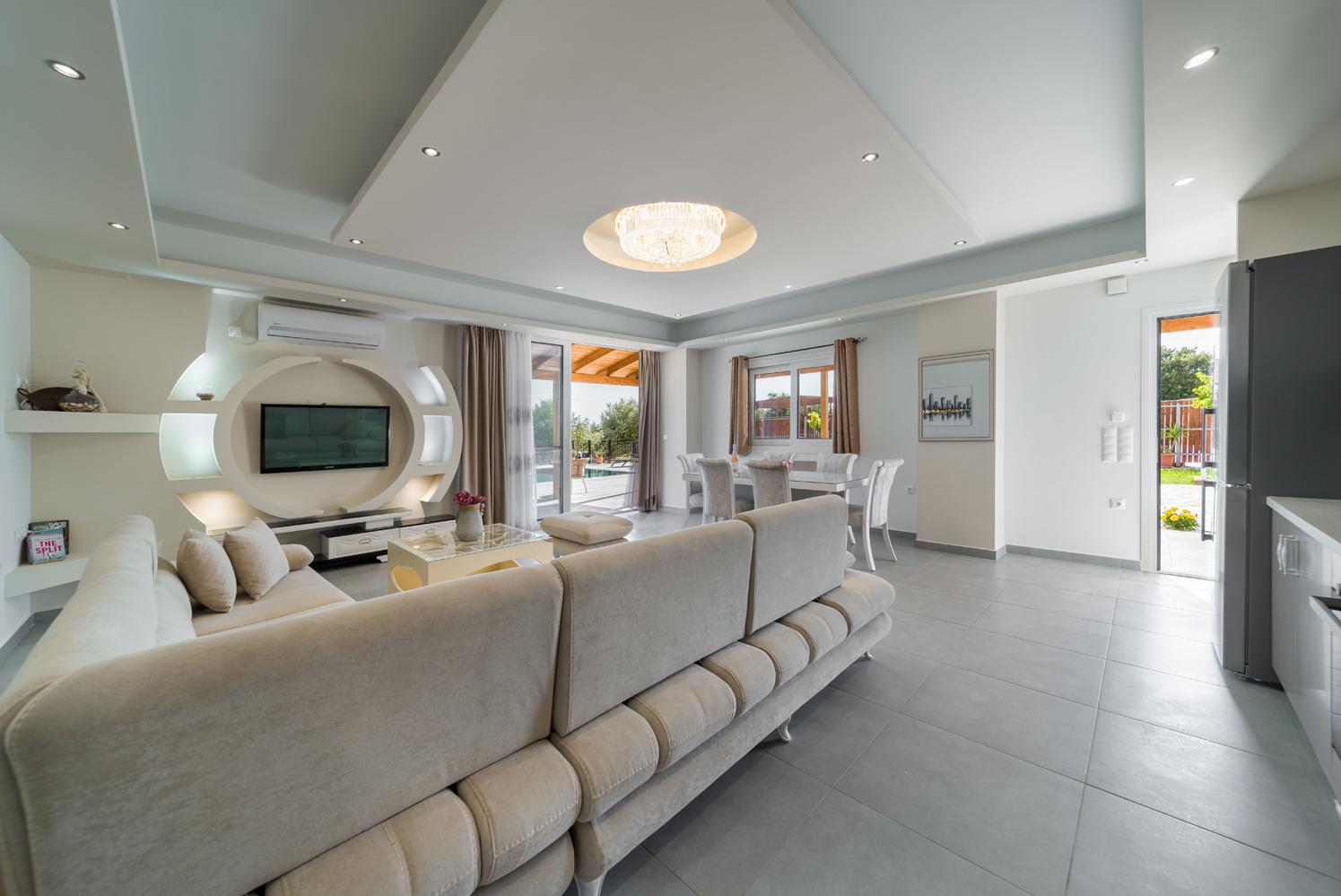 Open-plan living room with sofa, dining area, kitchen, WiFi internet, satellite TV