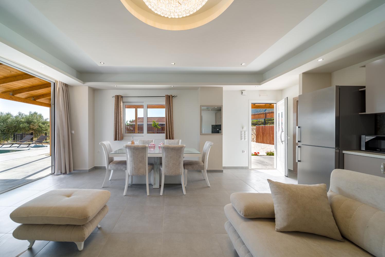Open-plan living room with sofa, dining area, kitchen, WiFi internet, satellite TV