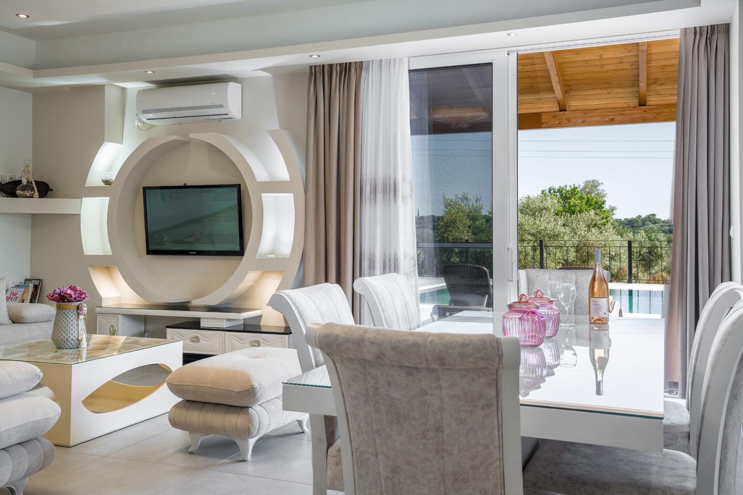 Open-plan living room with sofa, dining area, kitchen, WiFi internet, satellite TV