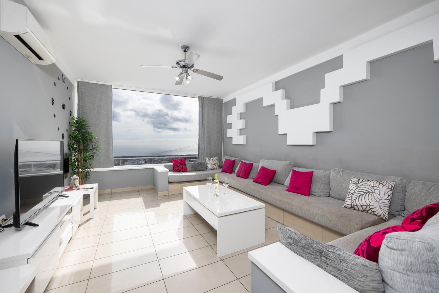 Living room with sofa, dining area, A/C, WiFi internet, satellite TV, and sea views