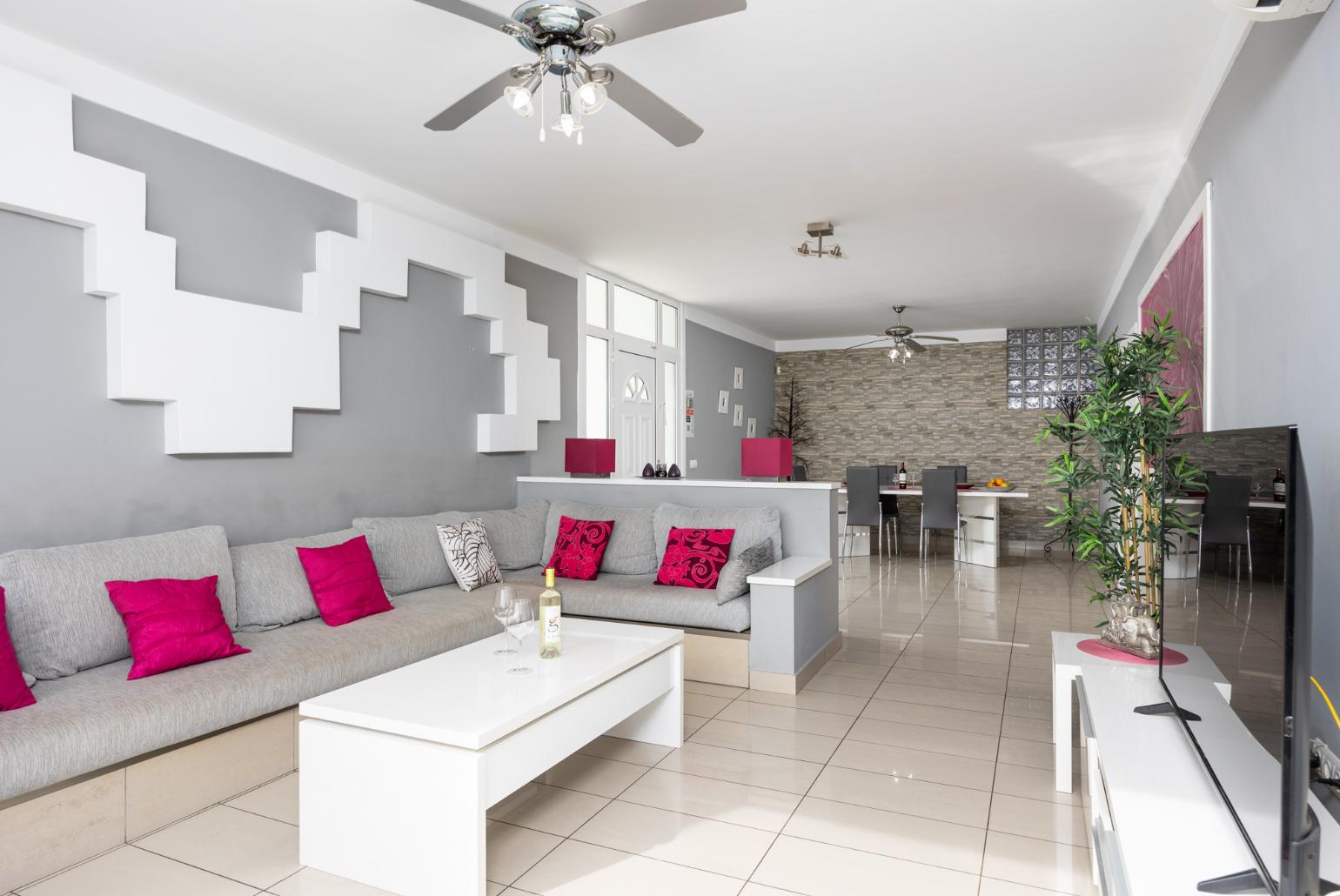 Living room with sofa, dining area, A/C, WiFi internet, satellite TV, and sea views