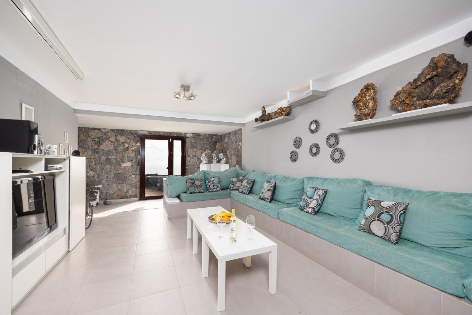 Living room with sofa, TV, and pool table