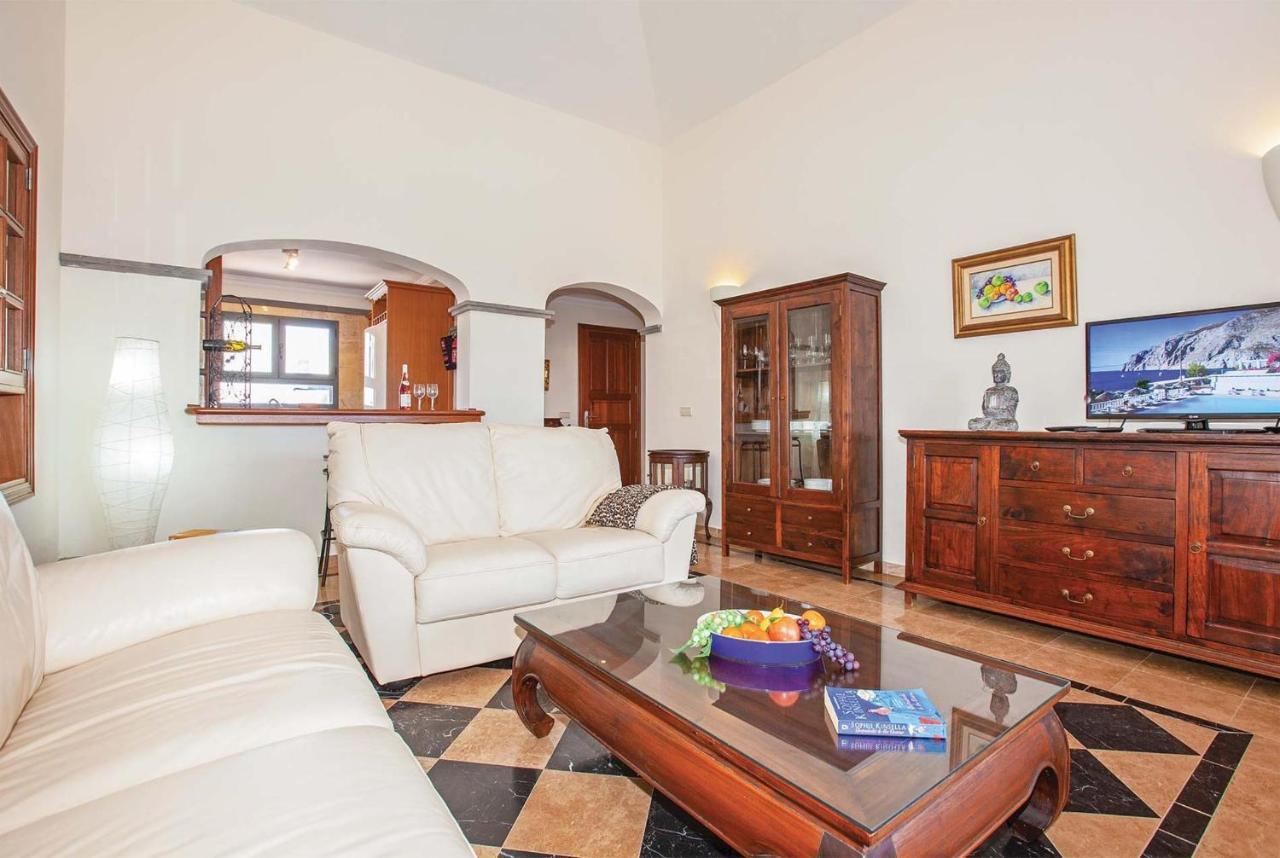 Open-plan living room with sofa, dining area, kitchen, WiFi internet, satellite TV, and sea views