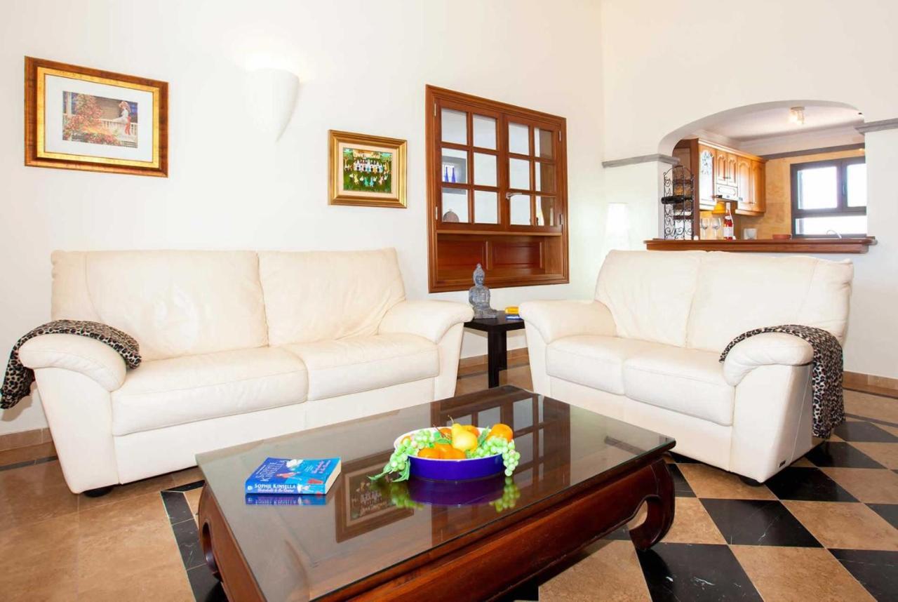 Open-plan living room with sofa, dining area, kitchen, WiFi internet, satellite TV, and sea views