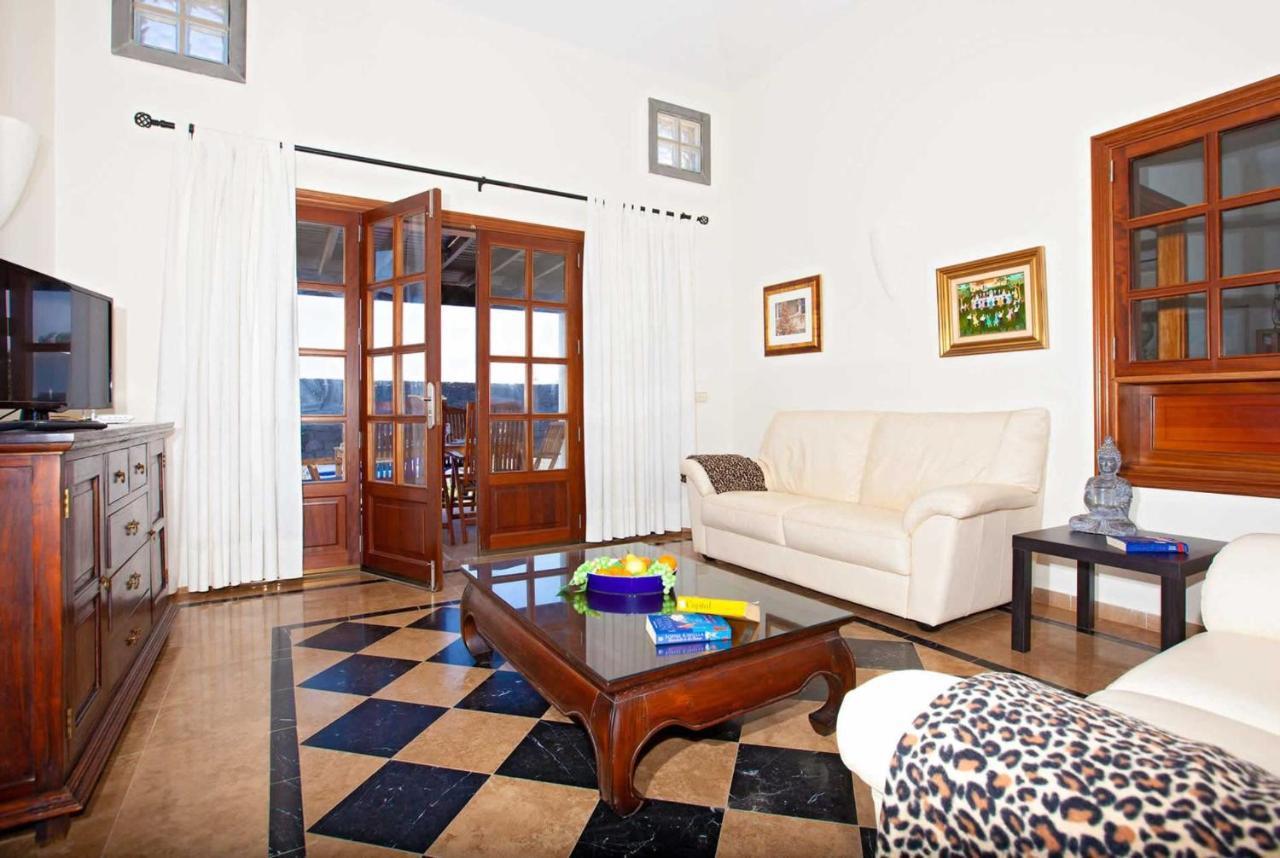 Open-plan living room with sofa, dining area, kitchen, WiFi internet, satellite TV, and sea views