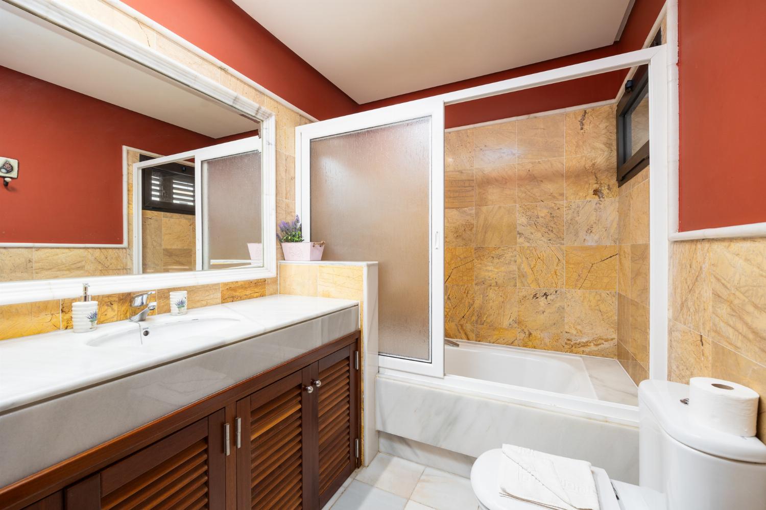 En suite bathroom with bath and shower