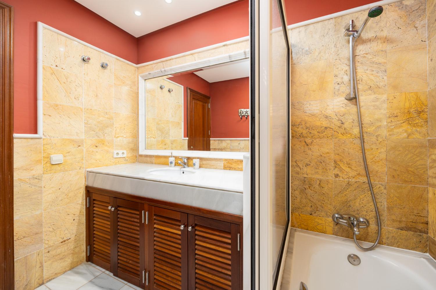 En suite bathroom with bath and shower