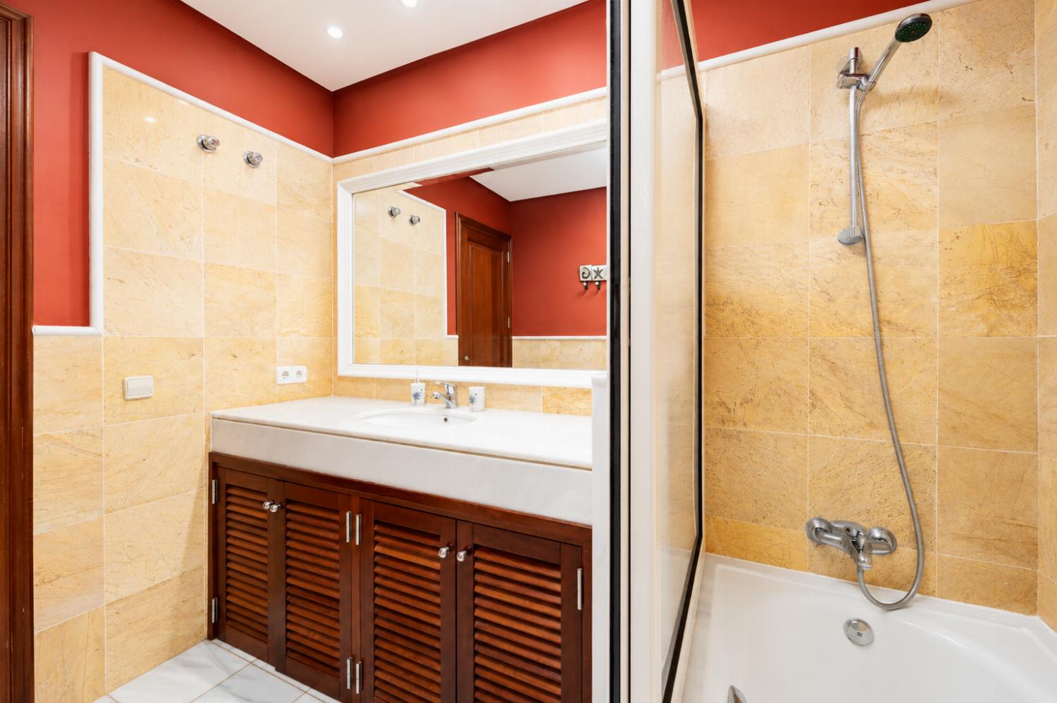 En suite bathroom with bath and shower