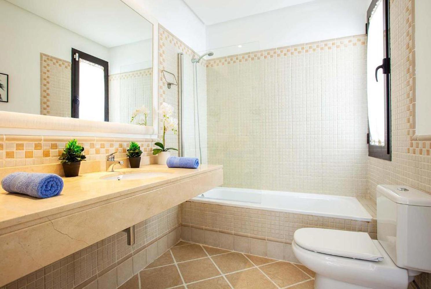 En suite bathroom with bath and WC