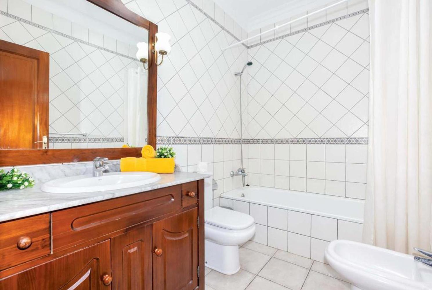 En suite bathroom with bath and WC