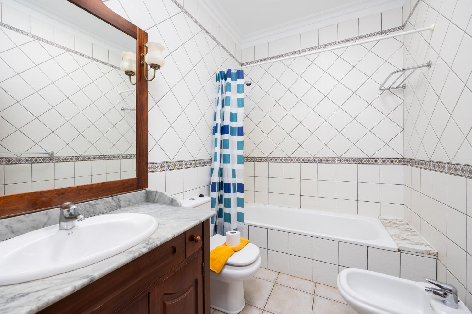 En suite bathroom with bath and shower