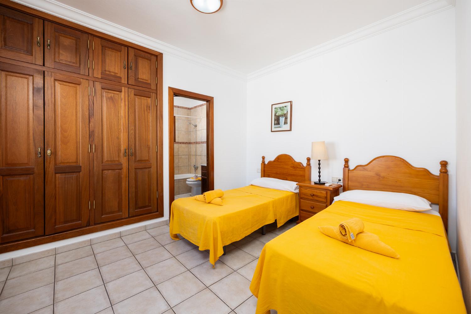 Twin bedroom with en suite bathroom and A/C