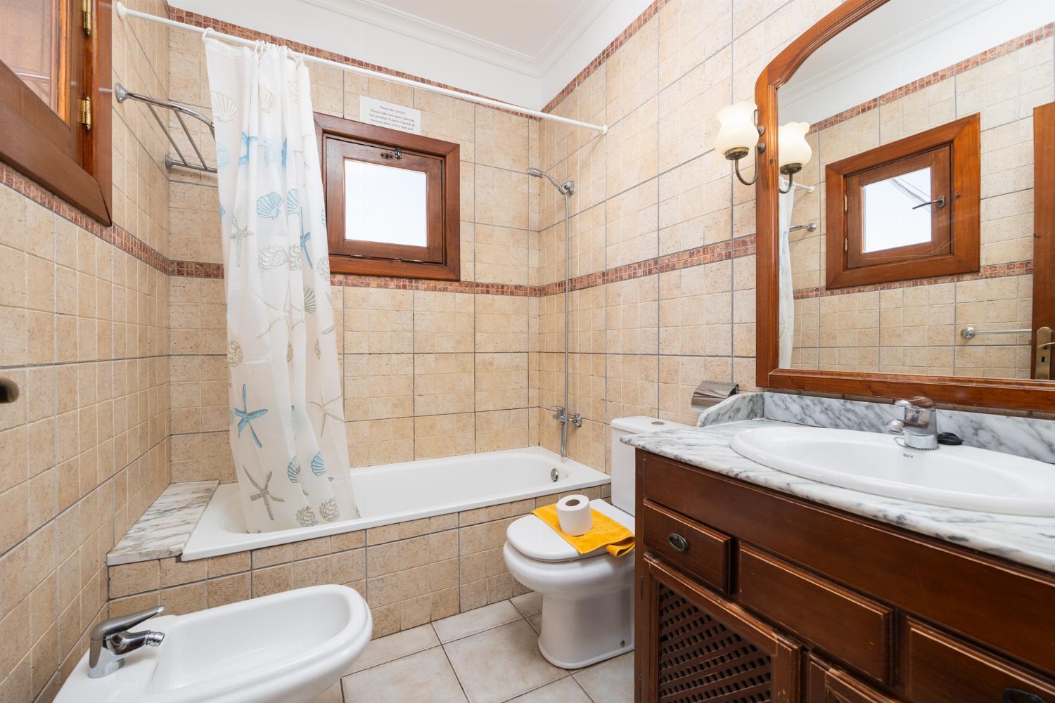 En suite bathroom with bath and shower