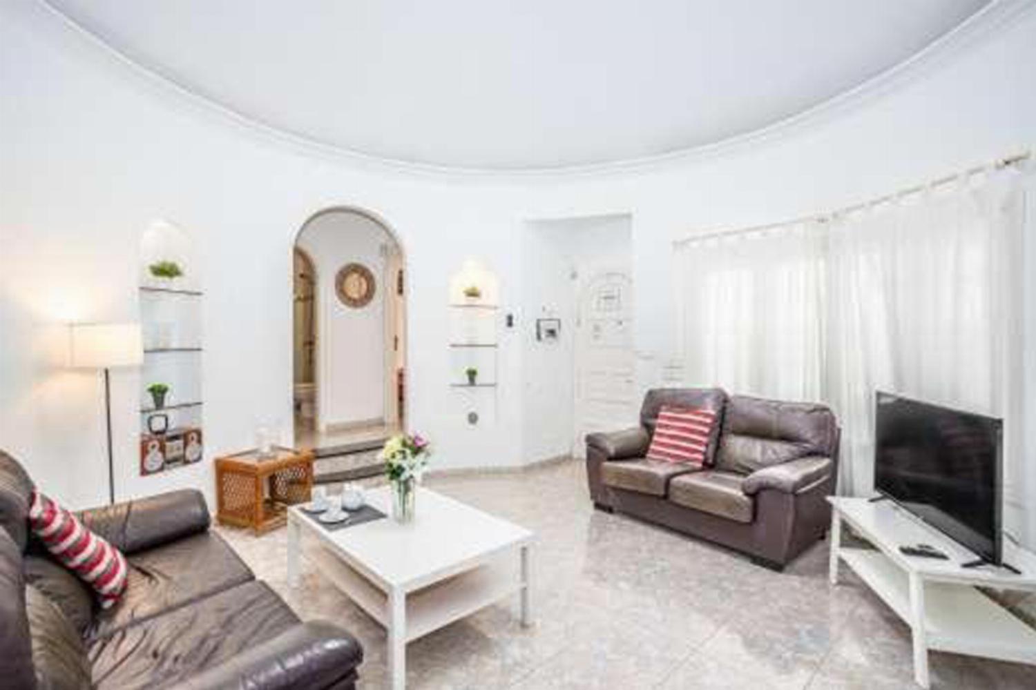 Open-plan living room with sofa, dining area, kitchen, WiFi internet, satellite TV