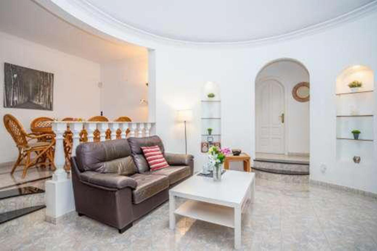 Open-plan living room with sofa, dining area, kitchen, WiFi internet, satellite TV