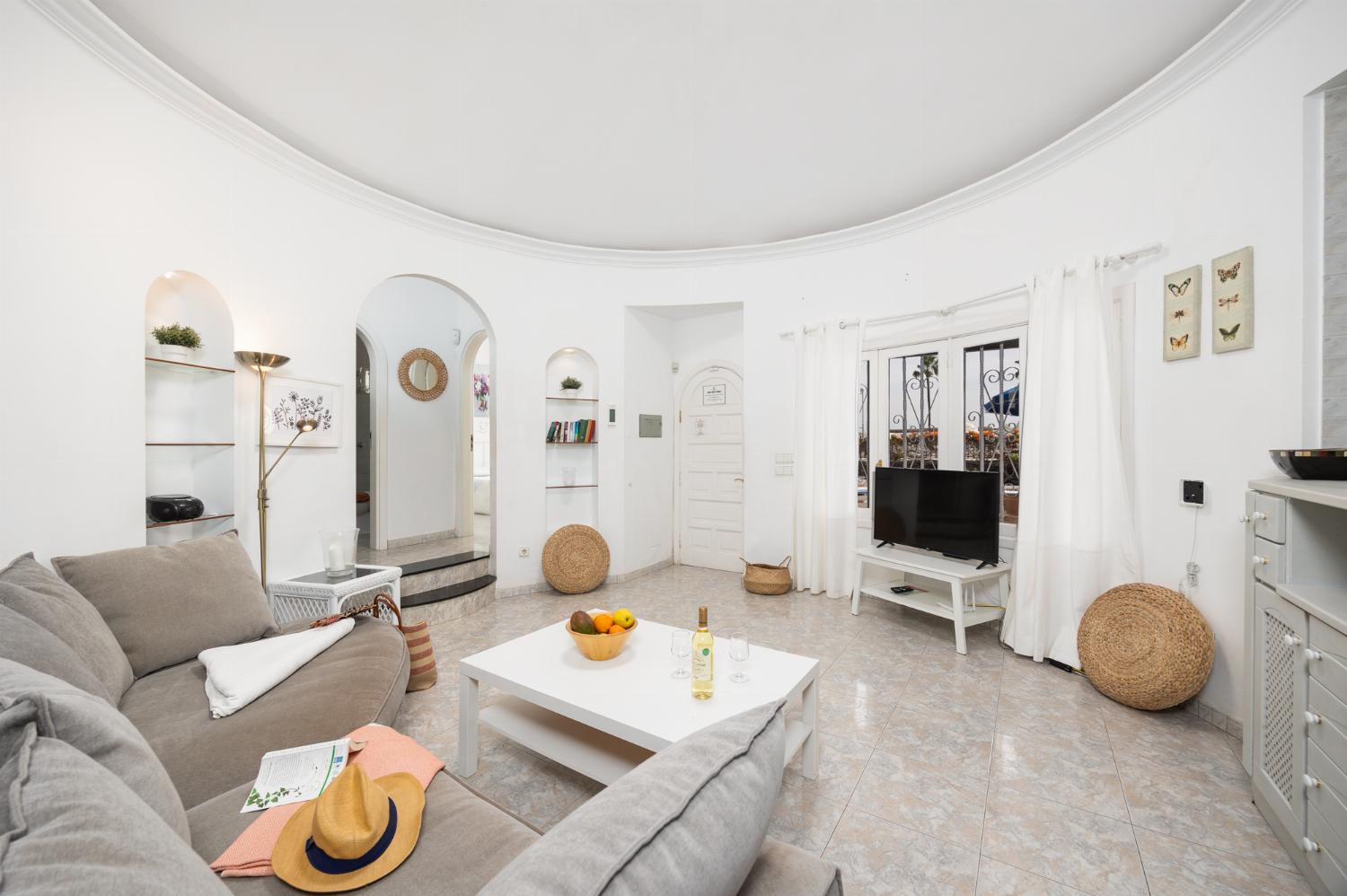 Open-plan living room with sofa, dining area, kitchen, WiFi internet, and satellite TV