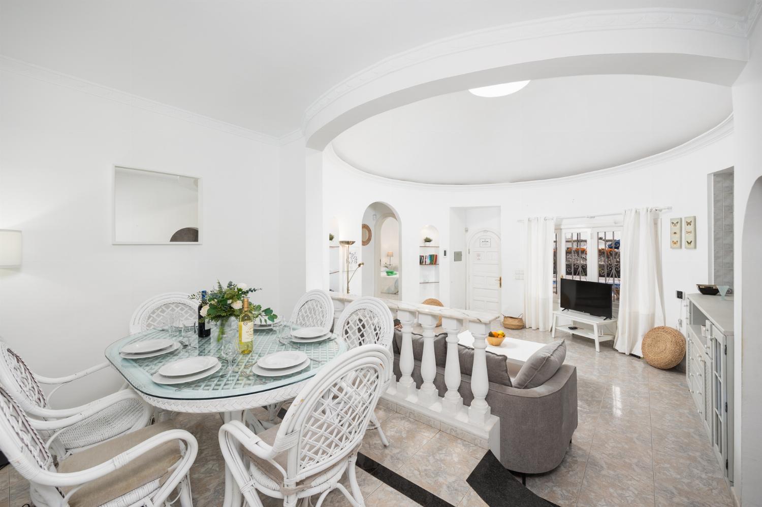 Open-plan living room with sofa, dining area, kitchen, WiFi internet, and satellite TV