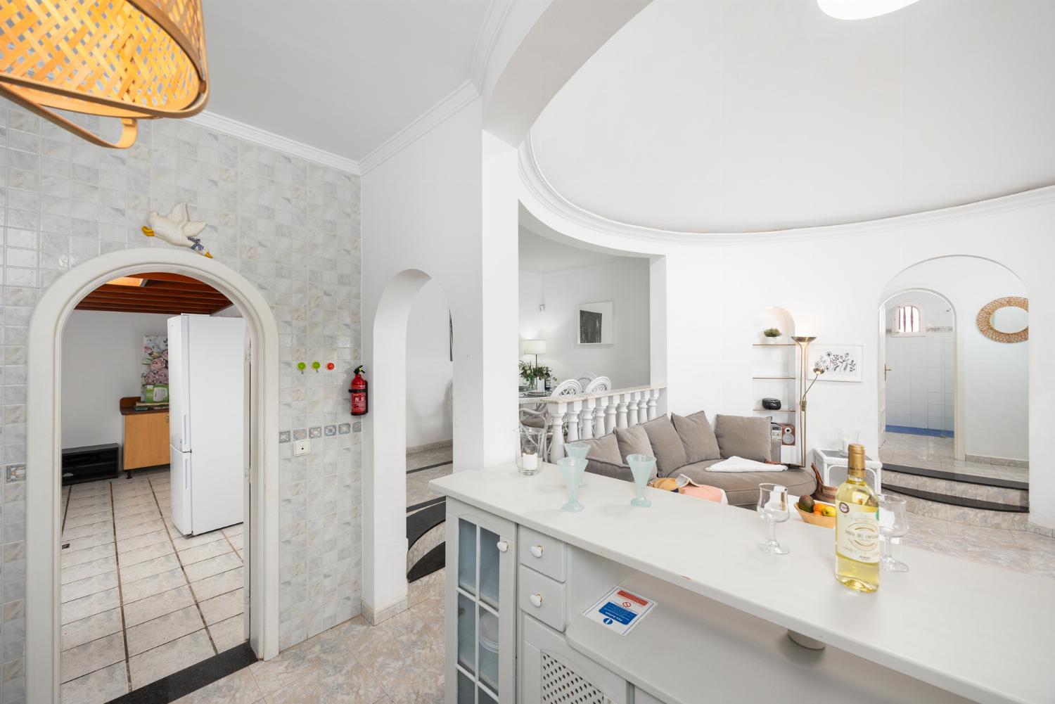 Open-plan living room with sofa, dining area, kitchen, WiFi internet, and satellite TV