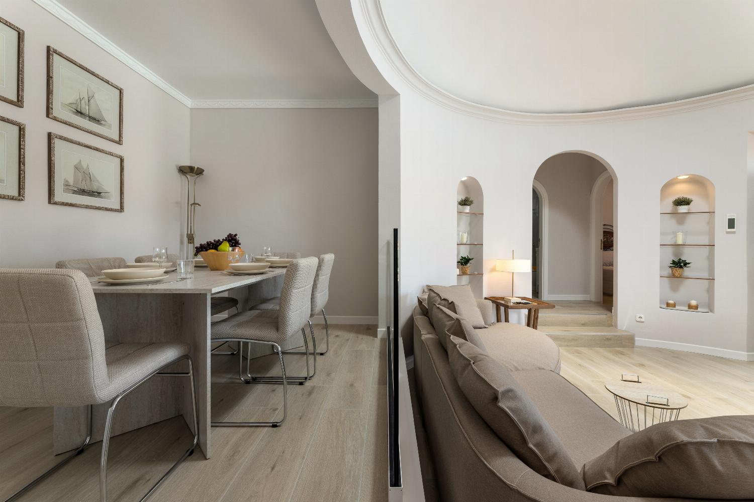 Open-plan living room with sofa, dining area, kitchen, WiFi internet, and satellite TV