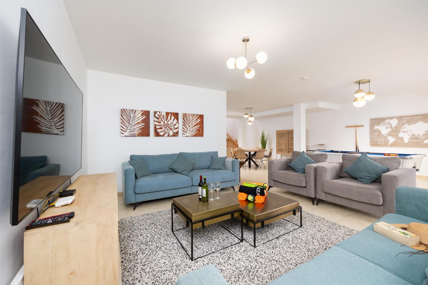 Living room with sofas, dining area, pool table, WiFi internet, and satellite TV