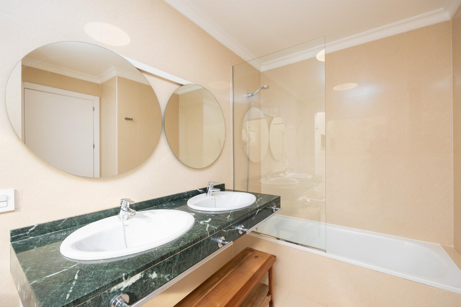 En suite bathroom with bath and shower