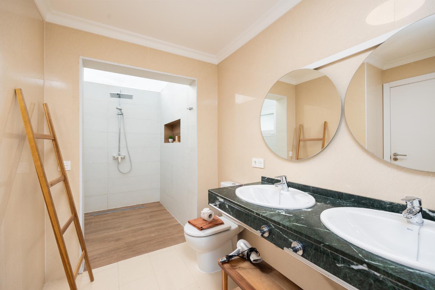 En suite bathroom with bath and shower