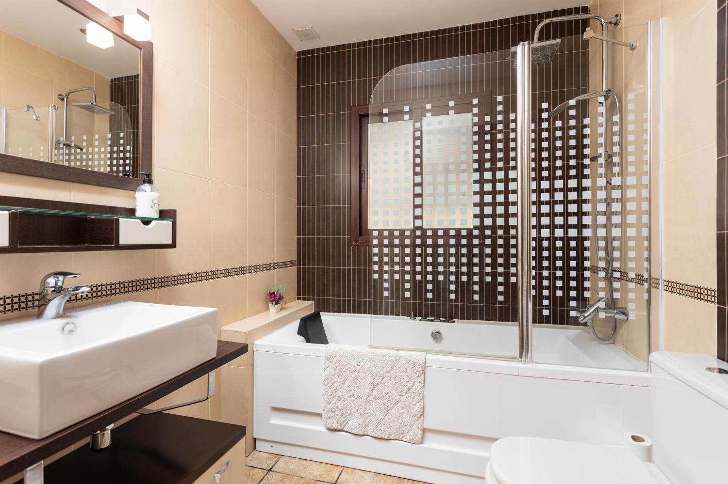 Family bathroom with bath and shower