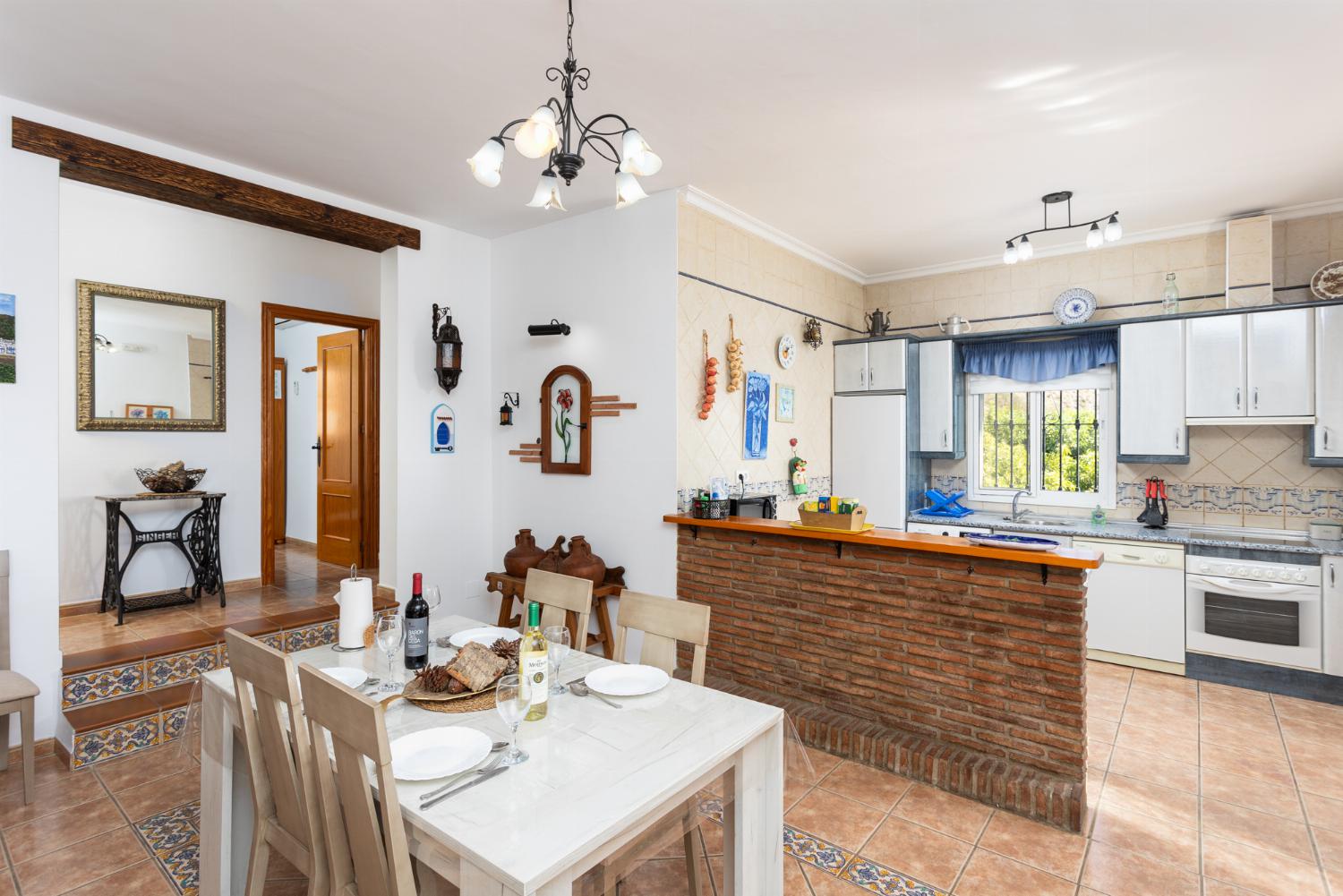 Open-plan living room with sofa, dining area, kitchen, ornamental fireplace, WiFi internet, and satellite TV
