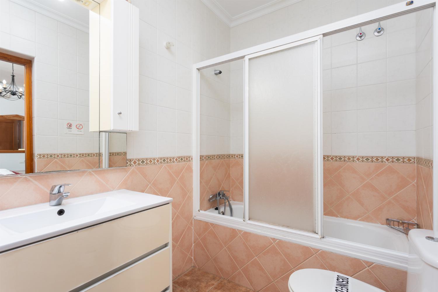 En suite bathroom with bath and shower
