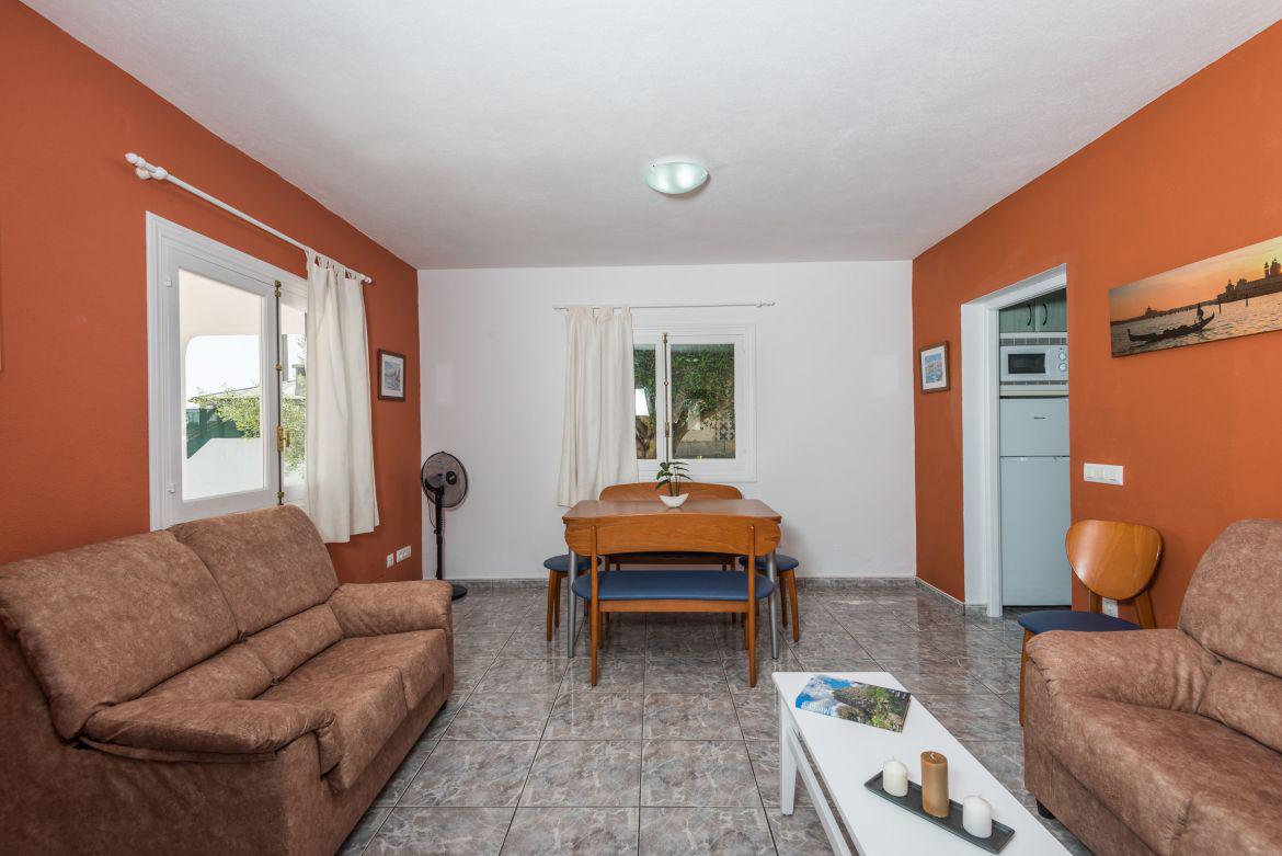 Open plan living room with comfortable sofas, TV, WiFi and dining area