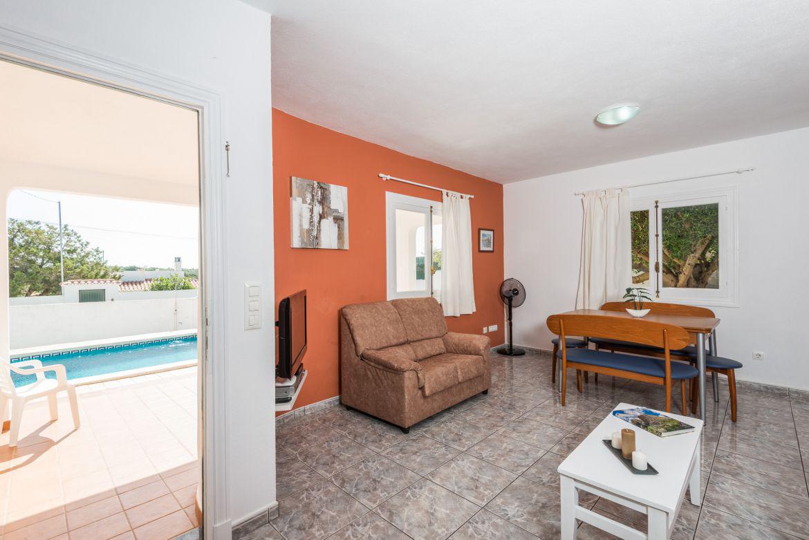 Open plan living room with comfortable sofas, TV, WiFi, patio doors and dining area