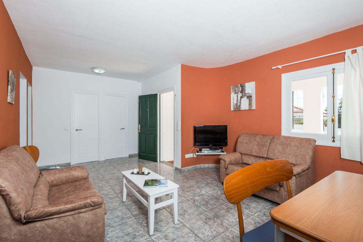 ,Open plan living room with comfortable sofas, TV, WiFi and dining area