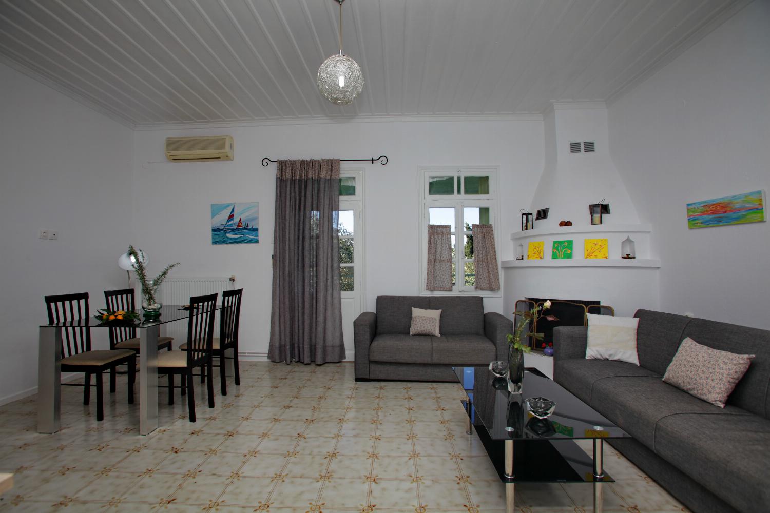 Open-plan living room with sofa, dining area, kitchen, WiFi internet, satellite TV