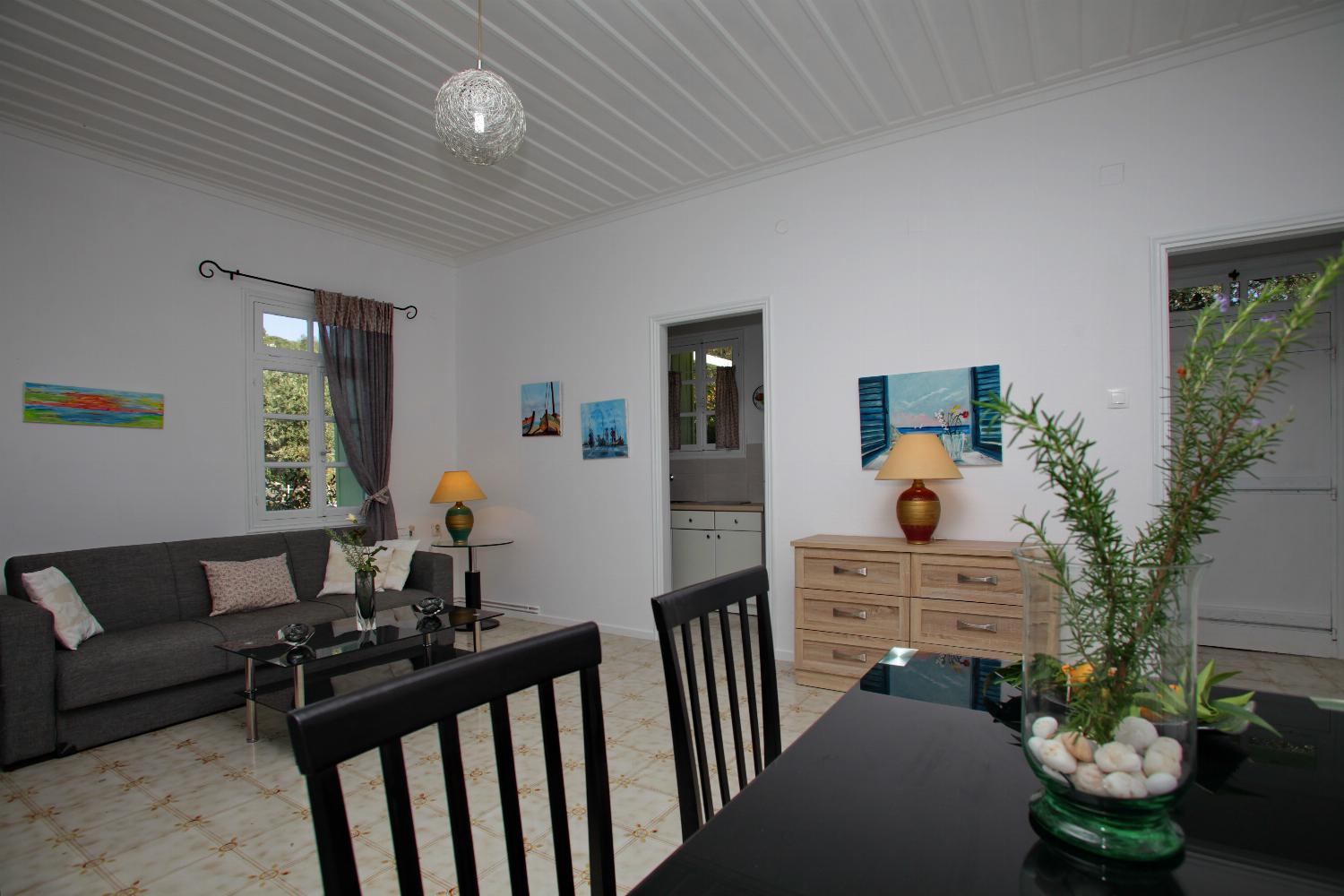 Open-plan living room with sofa, dining area, kitchen, WiFi internet, satellite TV